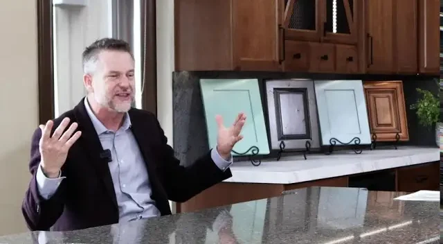 Showroom display of custom cabinet door samples in various finishes, with a representative discussing Hiebert Cabinets’ craftsmanship and design options.