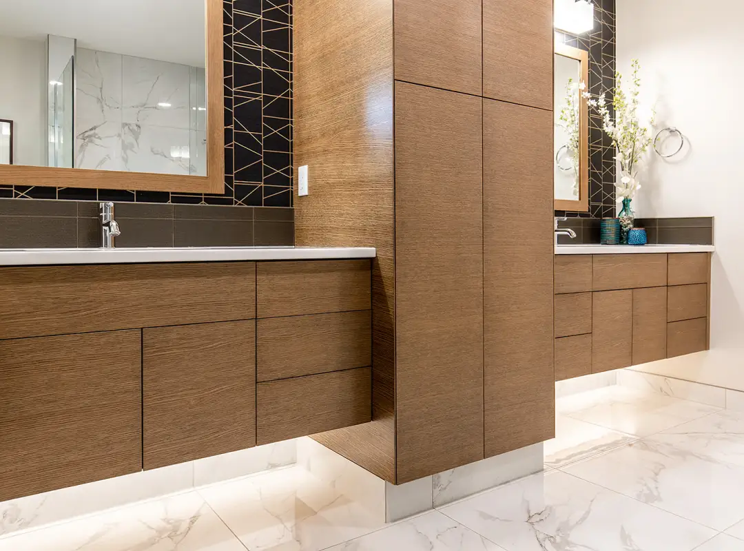Modern bathroom with floating custom wood vanities and full-height cabinetry, featuring clean lines and premium millwork crafted by Hiebert Cabinets.