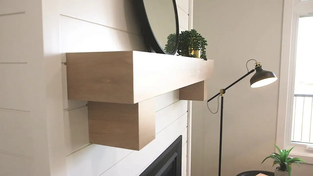 Custom wood fireplace mantel with clean modern lines and smooth millwork craftsmanship by Hiebert Cabinets.